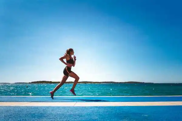 Woman running showing strong leg muscle Stansted